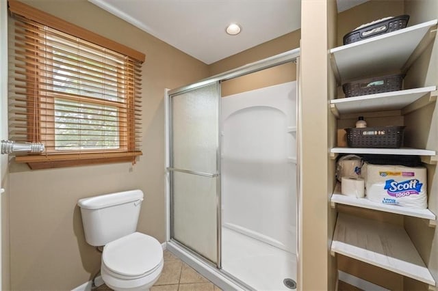 full bath with a stall shower, recessed lighting, toilet, and tile patterned floors