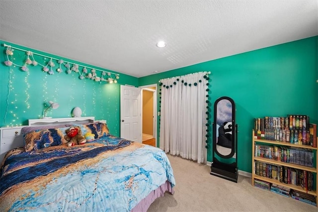 bedroom with a textured ceiling, carpet flooring, and baseboards