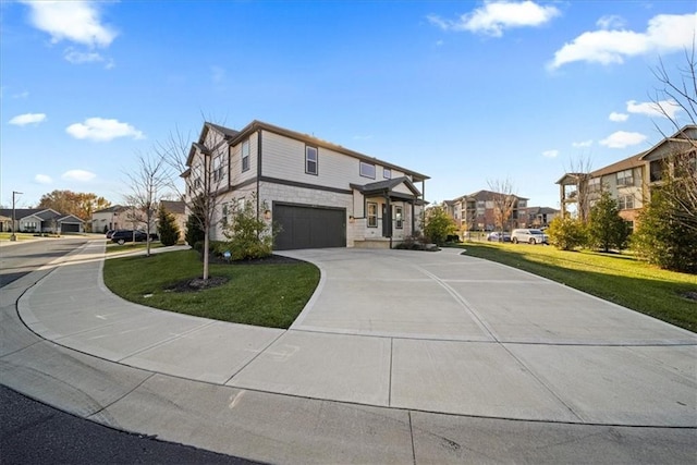 view of front of property featuring a garage, a residential view, concrete driveway, and a front yard