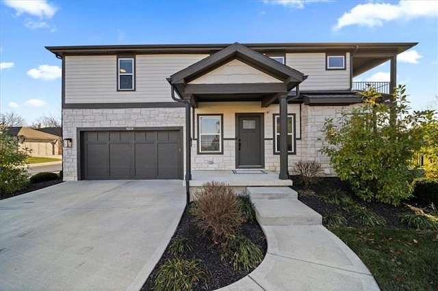 view of front of home with stone siding, driveway, and an attached garage