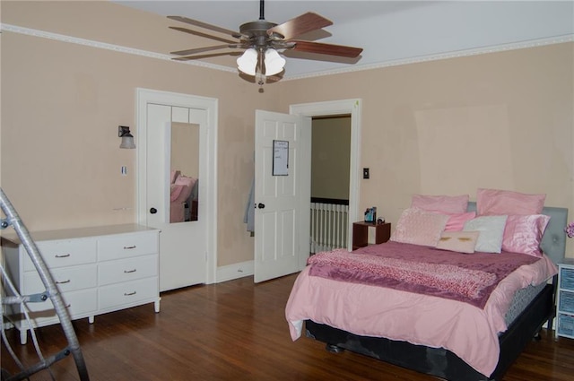 bedroom with a ceiling fan, baseboards, ornamental molding, and dark wood-style flooring