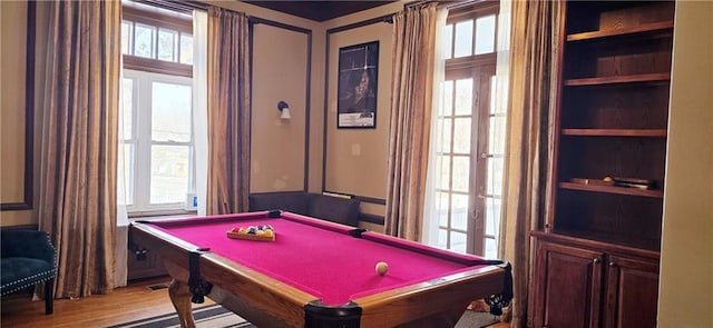 rec room with light wood-style floors, billiards, and built in features