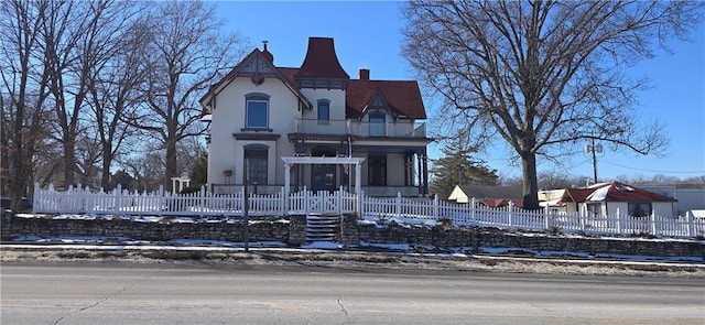 victorian house with a fenced front yard