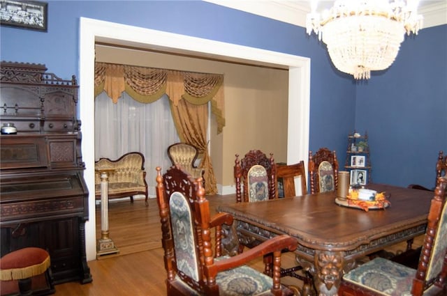 dining room with light wood finished floors and an inviting chandelier