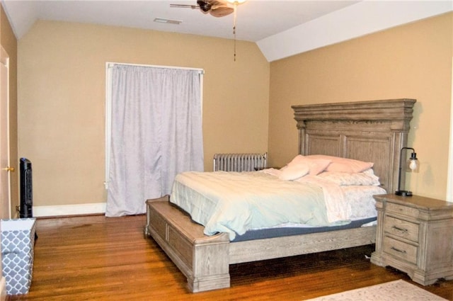 bedroom with lofted ceiling, radiator heating unit, a ceiling fan, light wood-type flooring, and baseboards