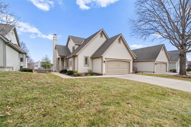 view of front of house with a front yard, an attached garage, stucco siding, a chimney, and concrete driveway