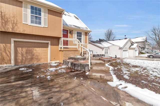 split level home with a garage and a residential view