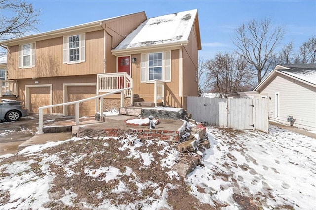 tri-level home with a gate and an attached garage