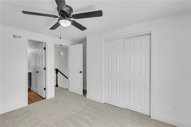 unfurnished bedroom with ensuite bathroom, visible vents, baseboards, a closet, and carpet