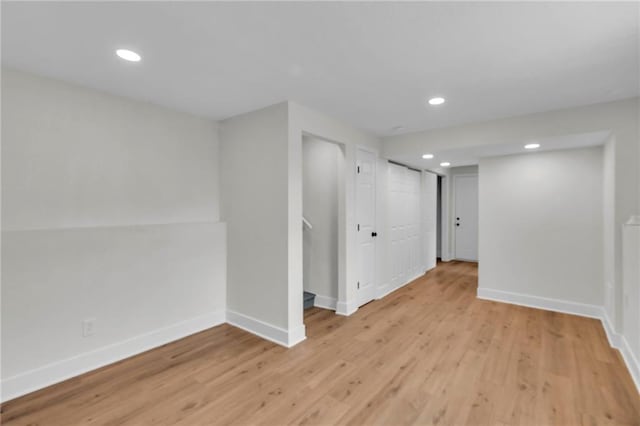 basement with light wood-style floors, baseboards, and recessed lighting