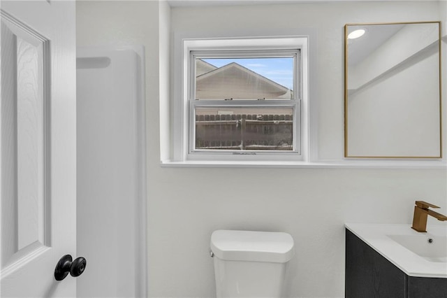 bathroom featuring vanity and toilet