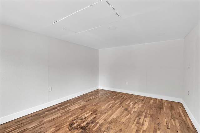 spare room featuring wood finished floors and baseboards