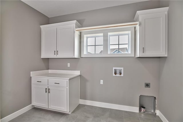 clothes washing area featuring light tile patterned floors, hookup for a washing machine, cabinet space, hookup for an electric dryer, and baseboards