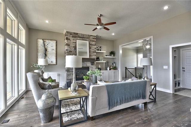 living room with dark wood-style floors, a fireplace, and recessed lighting