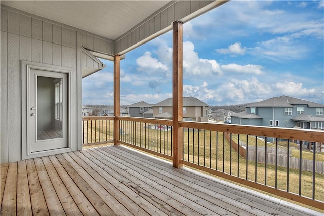 wooden terrace featuring a residential view and a yard