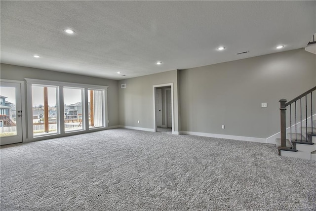 unfurnished living room featuring carpet, stairs, baseboards, and recessed lighting