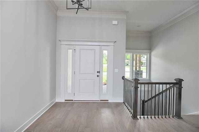 2850 W Wabash St, Olathe, KS 66061 - entryway featuring crown molding, wood finished floors, baseboards, and a chandelier