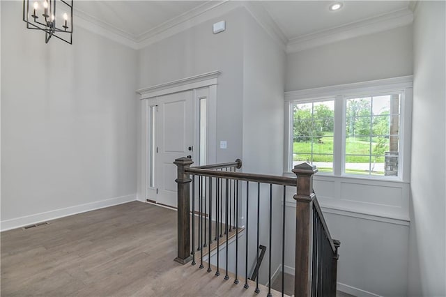 2850 W Wabash St, Olathe, KS 66061 - stairway with ornamental molding, wood finished floors, a chandelier, recessed lighting, and baseboards