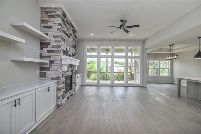 2850 W Wabash St, Olathe, KS 66061 - unfurnished living room featuring ceiling fan, a fireplace, light wood-style flooring, and recessed lighting