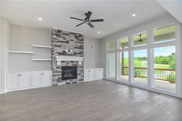 2850 W Wabash St, Olathe, KS 66061 - unfurnished living room with ceiling fan, wood finished floors, a stone fireplace, and recessed lighting