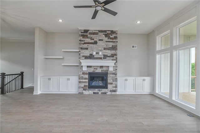 2850 W Wabash St, Olathe, KS 66061 - unfurnished living room featuring ceiling fan, wood finished floors, a fireplace, recessed lighting, and crown molding