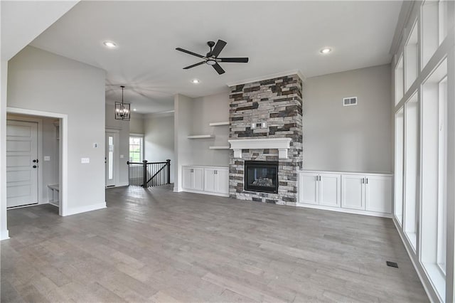2850 W Wabash St, Olathe, KS 66061 - unfurnished living room featuring a ceiling fan, light wood-style floors, a chandelier, recessed lighting, and a fireplace