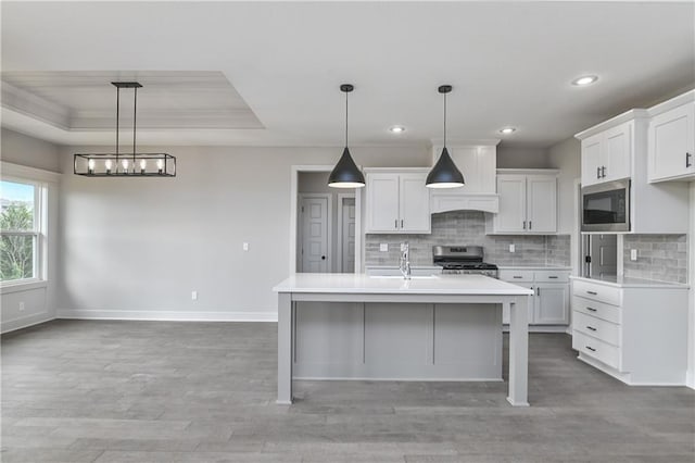 2850 W Wabash St, Olathe, KS 66061 - kitchen with appliances with stainless steel finishes, light countertops, baseboards, tasteful backsplash, and white cabinetry