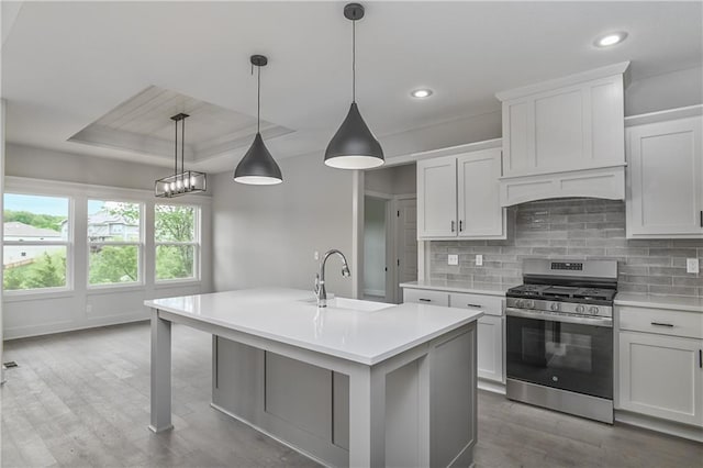 2850 W Wabash St, Olathe, KS 66061 - kitchen featuring gas range, a sink, light countertops, decorative backsplash, and recessed lighting