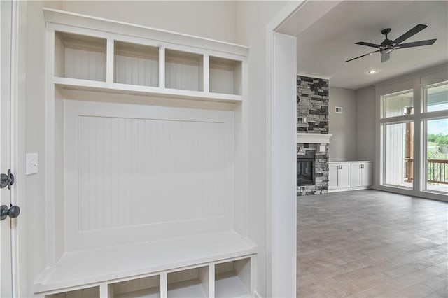 2850 W Wabash St, Olathe, KS 66061 - mudroom with wood finished floors, a ceiling fan, and a fireplace