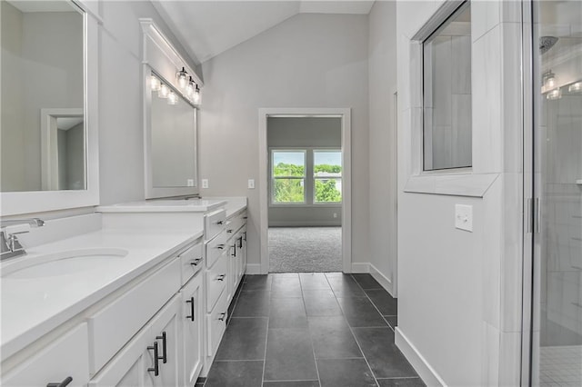 2850 W Wabash St, Olathe, KS 66061 - bathroom with double vanity, lofted ceiling, tiled shower, tile patterned floors, and baseboards
