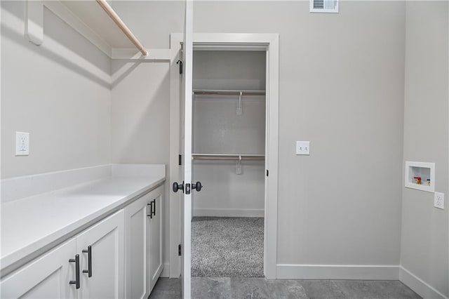 2850 W Wabash St, Olathe, KS 66061 - laundry room featuring hookup for a washing machine, baseboards, and cabinet space