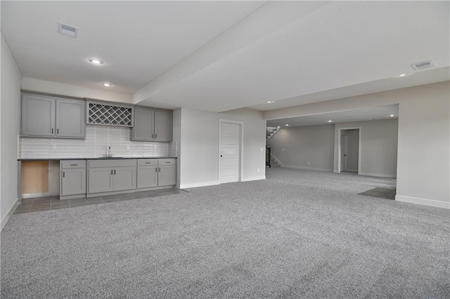 2850 W Wabash St, Olathe, KS 66061 - kitchen with gray cabinets, recessed lighting, baseboards, a sink, and tasteful backsplash