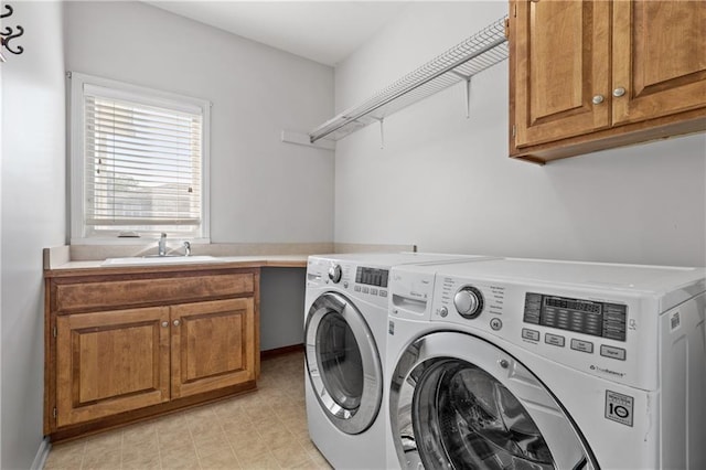 laundry area featuring cabinet space, a sink, and independent washer and dryer