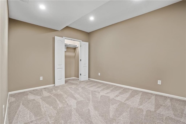 interior space featuring recessed lighting, baseboards, and light colored carpet