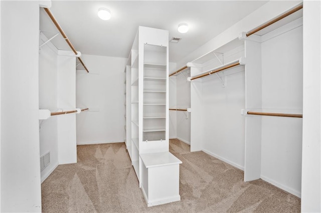 walk in closet featuring visible vents and light colored carpet