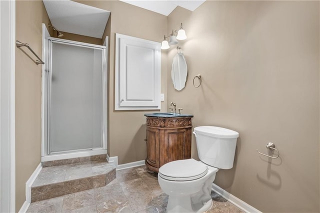 full bath with toilet, a shower stall, baseboards, and vanity