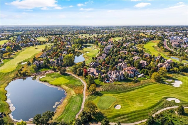 drone / aerial view featuring view of golf course, a water view, and a residential view