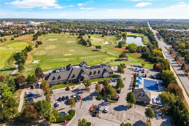 drone / aerial view featuring view of golf course and a water view