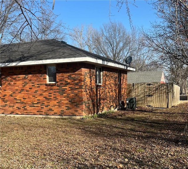 view of side of home with brick siding