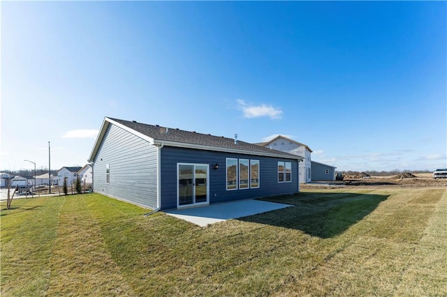 rear view of property with a patio and a lawn