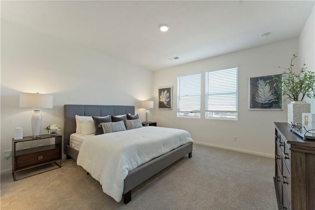 bedroom featuring baseboards, carpet flooring, and visible vents