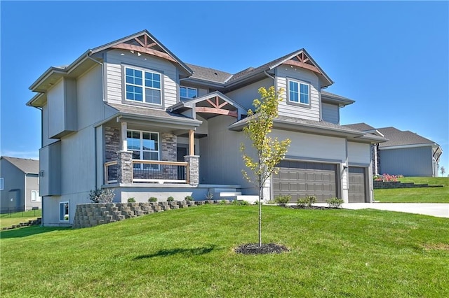 craftsman-style home with an attached garage, stone siding, driveway, and a front lawn