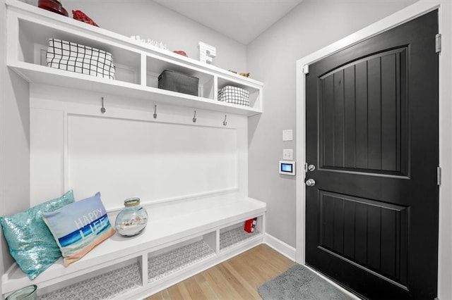 mudroom with baseboards and wood finished floors