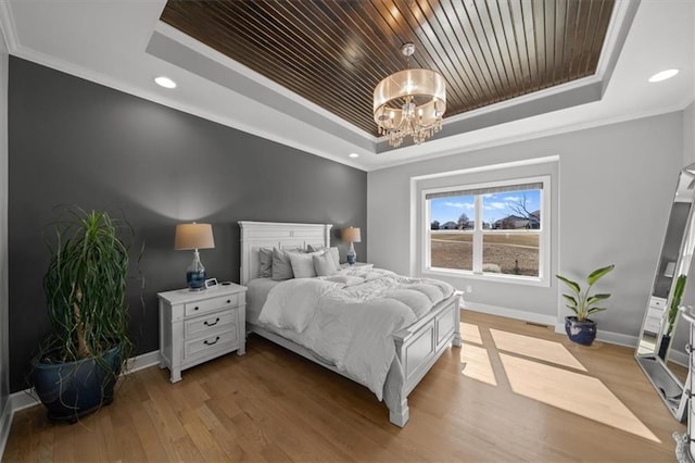 bedroom featuring baseboards, wood ceiling, a tray ceiling, crown molding, and light wood-type flooring