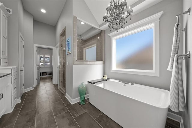 full bath featuring a freestanding tub, baseboards, a shower stall, and vanity