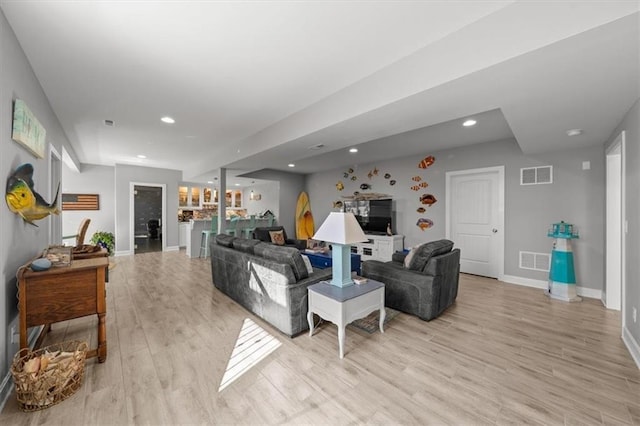 living area featuring recessed lighting, visible vents, and light wood-style floors