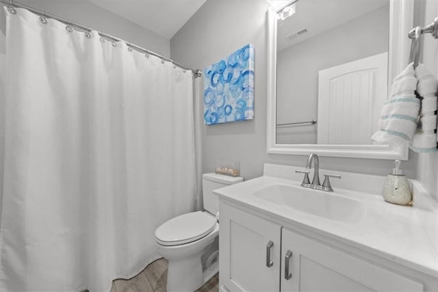 full bathroom with visible vents, vanity, and toilet