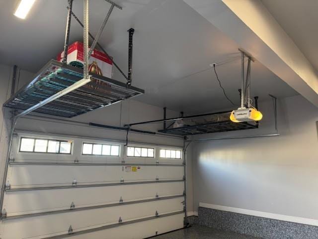 garage with baseboards and a garage door opener