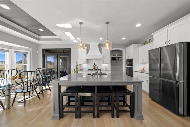 14423 N 145th St, Basehor, KS 66007 - kitchen with decorative backsplash, light wood-type flooring, freestanding refrigerator, custom exhaust hood, and recessed lighting