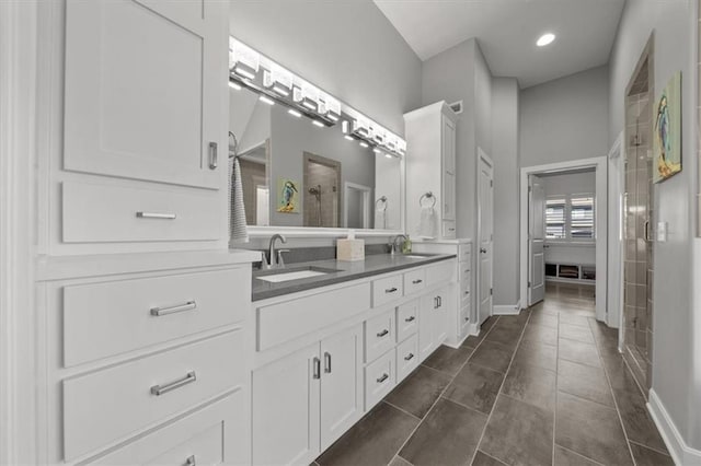 14423 N 145th St, Basehor, KS 66007 - bathroom featuring double vanity, a sink, baseboards, and a stall shower